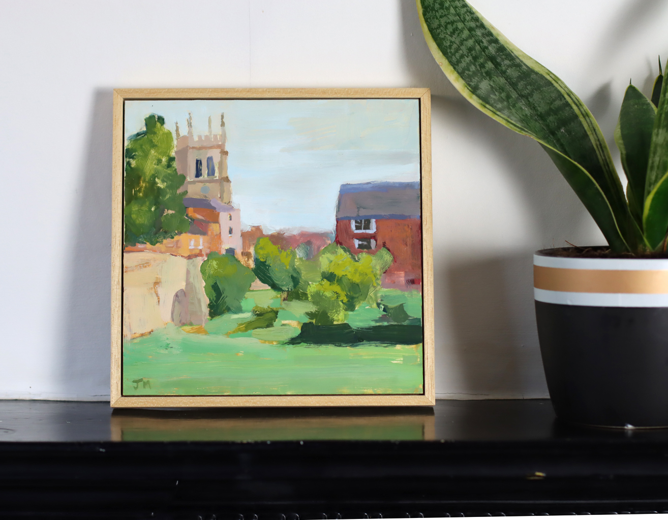 Church and house in setting near a river and bridge in Newport Pagnell