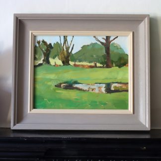 Landscape in greens and browns with reflections in the water