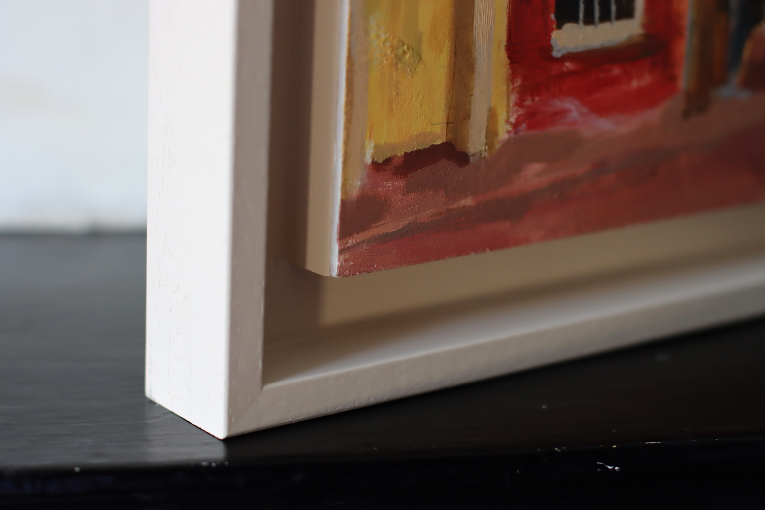 Corner of painting with cream float frame